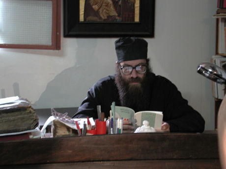 Father Grigorios counting pages