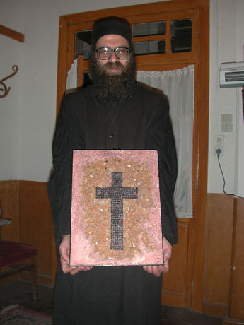 Father Grigorios holding his mosaic
